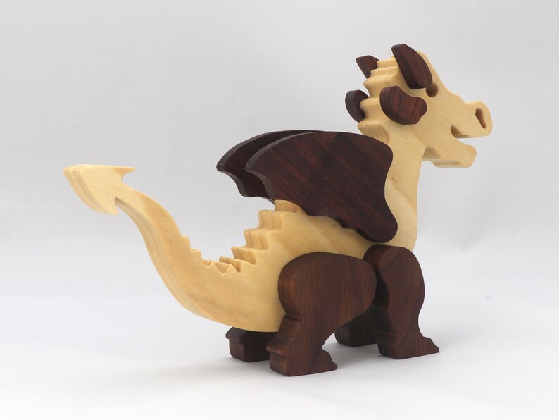 Wood Dragon Fantasy Animal Figurine is Handmade and finished with a renewable blend of mineral oil and waxes Applied hot for durabiliity and to enhance the beauty of the wood. There are ten dragons in this collection. A  link is in the description.