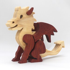 Hand-crafted baby dragon mythical fantasy animal figurine made from contrasting high-quality hardwoods and finished with non-toxic oils and waxes. Perfect for any dragon enthusiast.
