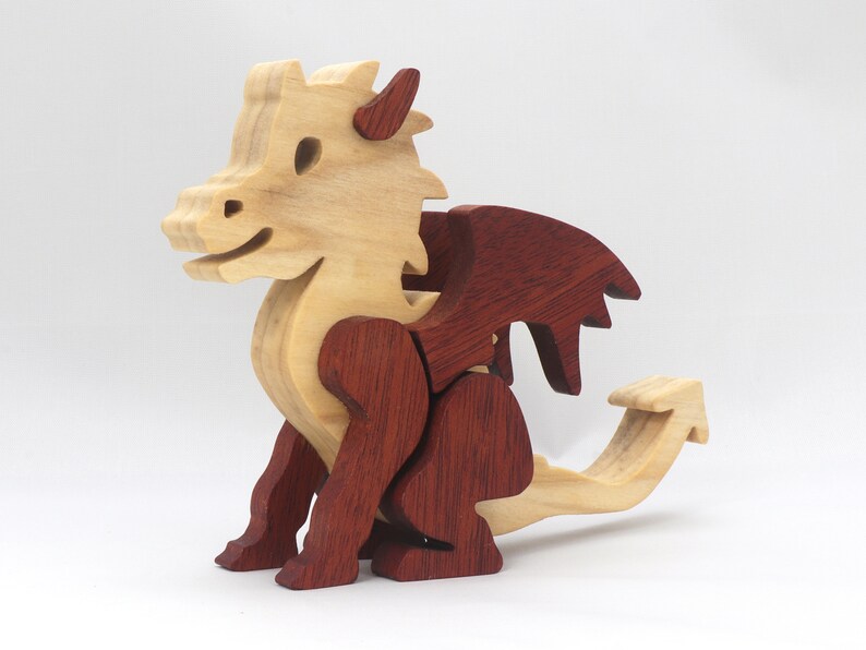 Hand-crafted baby dragon mythical fantasy animal figurine made from contrasting high-quality hardwoods and finished with non-toxic oils and waxes. Perfect for any dragon enthusiast.