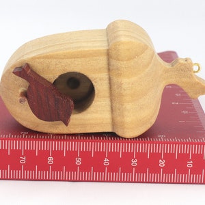 Handmade wooden miniature birdhouse ornament cut from wood with rounded edges, natural wood grain and color variations, finished with non-toxic shellac or food-safe oils and beeswax, lightweight and ready to hang. Made in Tallahassee, Florida, USA, by Odin's Toy Factory.