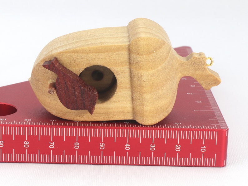 Handmade wooden miniature birdhouse ornament cut from wood with rounded edges, natural wood grain and color variations, finished with non-toxic shellac or food-safe oils and beeswax, lightweight and ready to hang. Made in Tallahassee, Florida, USA, by Odin's Toy Factory.