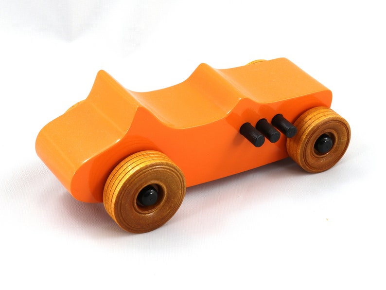 Handmade wooden toy car modeled after a 1927 T-Bucket hot rod. Finished with orange and black acrylic paint and amber shellac.