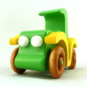Handmade wooden toy car, vintage-style Model T sedan, painted bright green and yellow with spoked wheels, finished in amber shellac.  Handcrafted in Tallahassee, Florida, USA by Odin's Toy Factory.