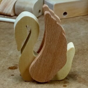 Handmade wooden swan figurine crafted from contrasting reclaimed hardwoods, sanded and ready to finish, and made in the USA.