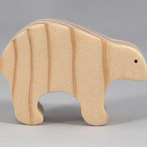 This is an unfinished wooden bear cutout from solid wood using traditional woodworking techniques. Sanded smooth and ready to paint, stain, or customize. Freestanding design for small hands, toddlers, young children, crafters, collectors, and display. I take custom orders for any animal, quantity, and mix — including large ornament orders. Mix and match, request a different size, or send a drawing or pattern. Handmade by Odin's Toy Factory in Tallahassee, Florida, USA.
