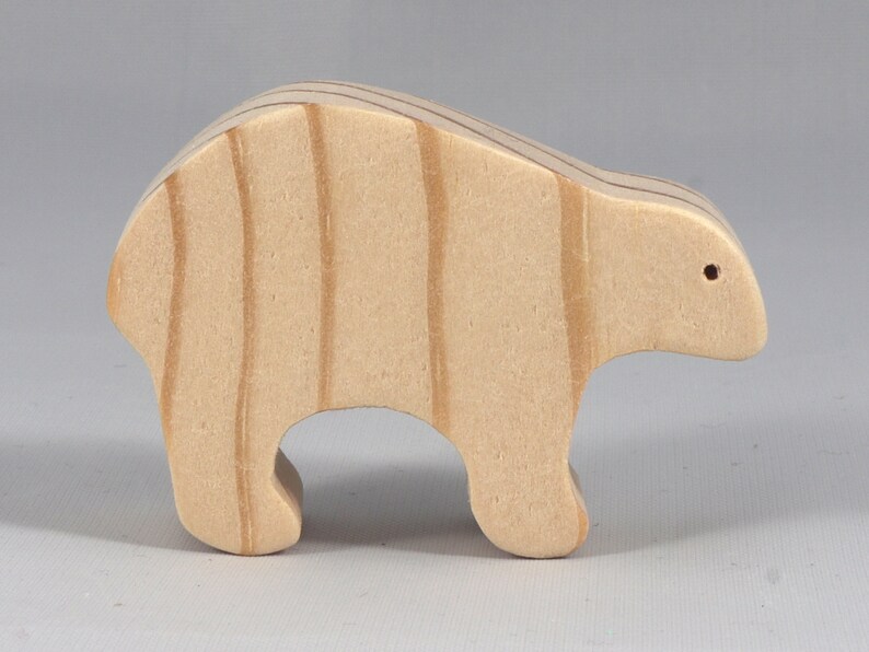 This is an unfinished wooden bear cutout from solid wood using traditional woodworking techniques. Sanded smooth and ready to paint, stain, or customize. Freestanding design for small hands, toddlers, young children, crafters, collectors, and display. I take custom orders for any animal, quantity, and mix — including large ornament orders. Mix and match, request a different size, or send a drawing or pattern. Handmade by Odin's Toy Factory in Tallahassee, Florida, USA.
