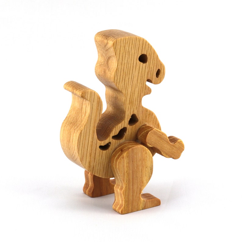 Handmade wooden baby dinosaur figurines, set of 3, made from hardwood with a natural oil and wax finish. Each baby dinosaur measures approximately 3 to 4 inches in height and length. Handmade in Tallahassee, Florida, USA at Odin's Toy Factory.