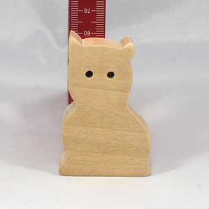 A handmade freestanding wooden toy cat cutout 1/2-3/4 inches thick is made from various kinds of wood sanded smooth and ready to paint. It is excellent for kids' crafts, pretend, or stacking toys. Other sizes are available with a custom order.