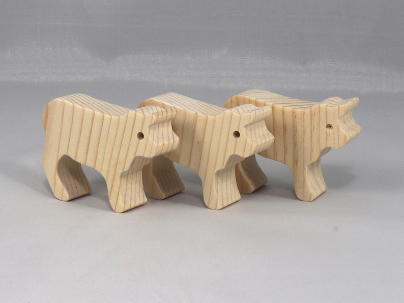 Handmade unfinished wooden toy baby calf cutout, unpainted and ready to paint, freestanding farm animal figure from Odin's Toy Factory’s  Itty Bitty Animal Collection. Handcrafted in Tallahassee, Florida, USA, using reclaimed natural wood offcuts. Perfect for imaginative play, stacking, collectors, and crafting.