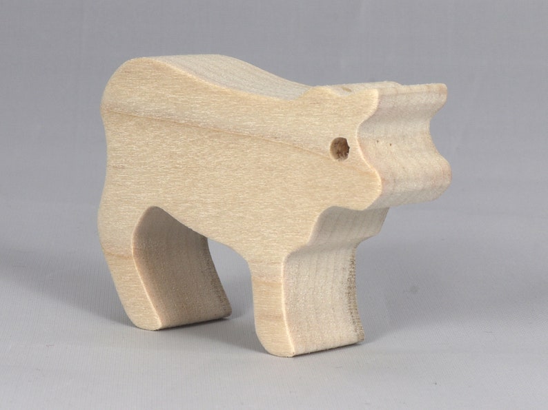 Handmade unfinished wooden toy baby calf cutout, unpainted and ready to paint, freestanding farm animal figure from Odin's Toy Factory’s  Itty Bitty Animal Collection. Handcrafted in Tallahassee, Florida, USA, using reclaimed natural wood offcuts. Perfect for imaginative play, stacking, collectors, and crafting.