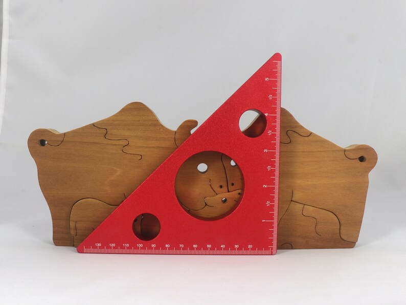 Wooden 6-piece bison family puzzle with two adult bison and four calves. The hardwood pieces interlock into one standing group or separate to stand alone. Handnmade in Tallahassee, Florida, USA by Odin's Toy Factory.