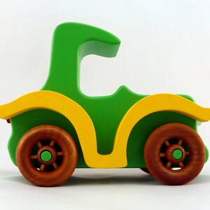 Handmade wooden toy car, vintage-style Model T sedan, painted bright green and yellow with spoked wheels, finished in amber shellac.  Handcrafted in Tallahassee, Florida, USA by Odin's Toy Factory.