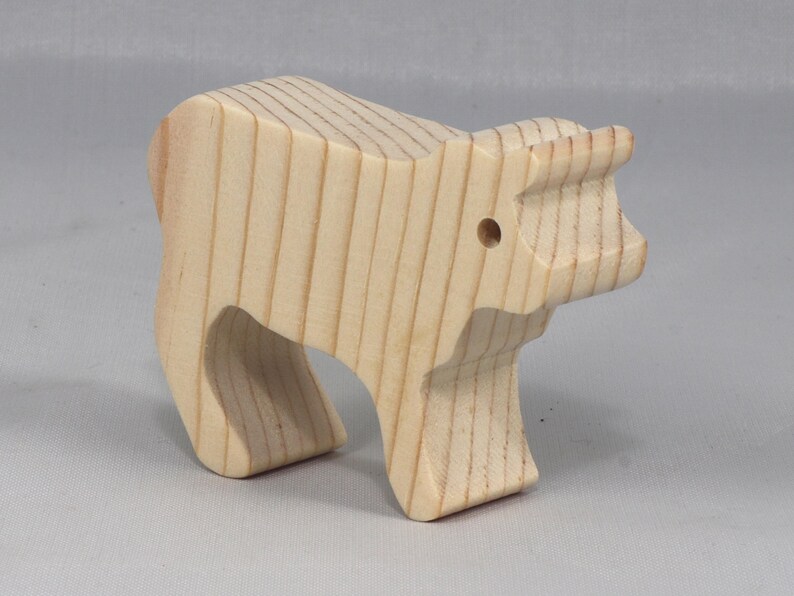 This is an unfinished wooden Calf cutout from solid wood using traditional woodworking techniques. Sanded smooth and ready to paint, stain, or customize. Freestanding design for small hands, toddlers, young children, crafters, collectors, and display. I take custom orders for any animal, quantity, and mix — including large ornament orders. Mix and match, request a different size, or send a drawing or pattern. Handmade by Odin's Toy Factory in Tallahassee, Florida, USA.