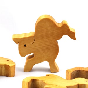 Handmade wooden toy stacking puzzle with five freestanding goats finished with a custom blend of nontoxic oils and waxes.