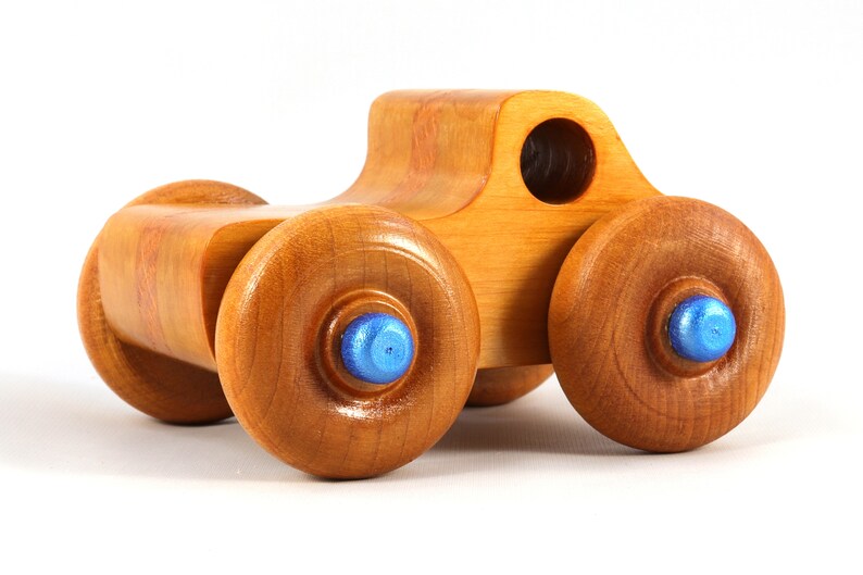 Wood Toy Monster Truck Handmade Form Hardwood and Finished With Amber Shellac With Metallic Saphire Blue Trim.