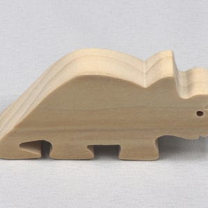 This is an unfinished wooden Wooden Toy Dinosaur Triceratops cutout from solid wood using traditional woodworking techniques. Sanded smooth and ready to paint, stain, or customize. Freestanding design for small hands, toddlers, young children, crafters, collectors, and display. I take custom orders for any animal, quantity, and mix — including large ornament orders. Mix and match, request a different size, or send a drawing or pattern. Handmade by Odin's Toy Factory in Tallahassee, Florida, USA.