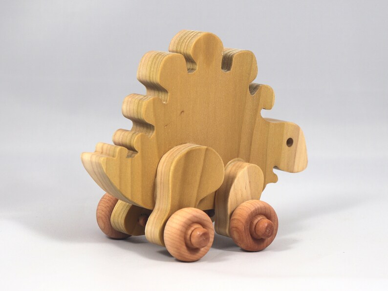 Handmade push toy stegosaurus crafted from select grade hardwoods and finished with a non-toxic coating.
