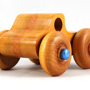 Wood Toy Monster Truck Handmade Form Hardwood and Finished With Amber Shellac With Metallic Saphire Blue Trim.