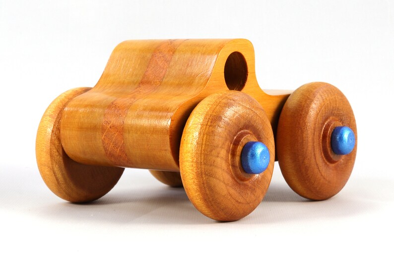 Wood Toy Monster Truck Handmade Form Hardwood and Finished With Amber Shellac With Metallic Saphire Blue Trim.