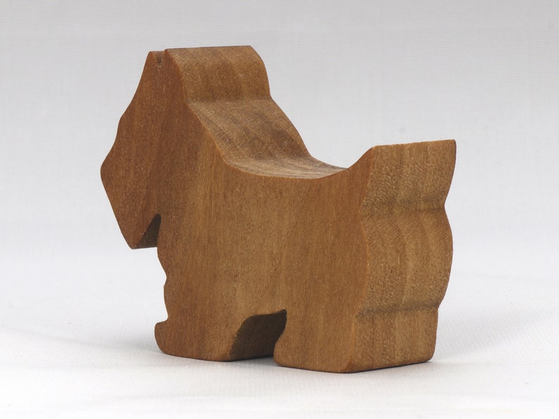 Handmade wooden Scottie dog toy cutout finished with mineral oil and beeswax blend. Freestanding stackable design from my Itty Bitty Animal Collection. Handcrafted in Tallahassee, Florida, USA from quality hardwood. Approximate size: length 2-1/2 inches, height 2 inches, width 3/4 inch. Each piece is unique with natural wood grain variations.