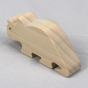 This is an unfinished wooden Wooden Toy Dinosaur Triceratops cutout from solid wood using traditional woodworking techniques. Sanded smooth and ready to paint, stain, or customize. Freestanding design for small hands, toddlers, young children, crafters, collectors, and display. I take custom orders for any animal, quantity, and mix — including large ornament orders. Mix and match, request a different size, or send a drawing or pattern. Handmade by Odin's Toy Factory in Tallahassee, Florida, USA.