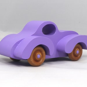 A Handmade Wood Toy Car Fat Fendered Coupe Hand Painted With Amethyst Acrylic Paint And Amber Shellac