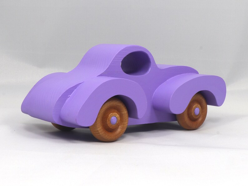 A Handmade Wood Toy Car Fat Fendered Coupe Hand Painted With Amethyst Acrylic Paint And Amber Shellac