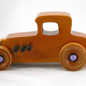 Handmade wooden toy car '27 T-Coupe, finished with amber shellac, metallic purple, and black acrylic paint. Made to order.