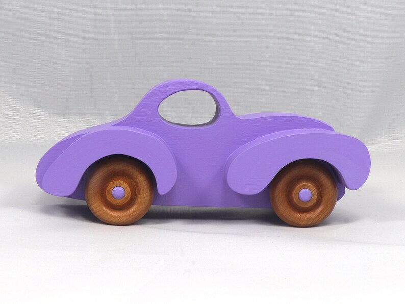 A Handmade Wood Toy Car Fat Fendered Coupe Hand Painted With Amethyst Acrylic Paint And Amber Shellac