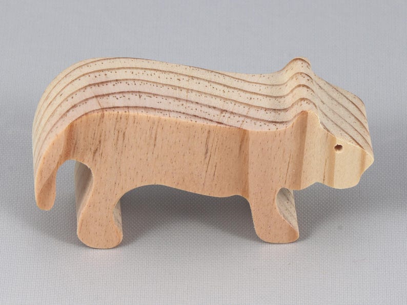This is an unfinished wooden lioness cutout from solid wood using traditional woodworking techniques. Sanded smooth and ready to paint, stain, or customize. Freestanding design for small hands, toddlers, young children, crafters, collectors, and display. I take custom orders for any animal, quantity, and mix — including large ornament orders. Mix and match, request a different size, or send a drawing or pattern. Handmade by Odin's Toy Factory in Tallahassee, Florida, USA.