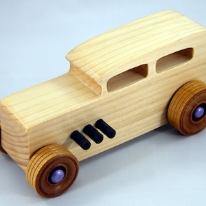 Handmade wooden toy car Hot Rod '32 Sedan finished with polyurethane, metallic purple and black trim, and nonmarring amber shellac wheels.