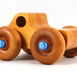 Wood Toy Monster Truck Handmade Form Hardwood and Finished With Amber Shellac With Metallic Saphire Blue Trim.