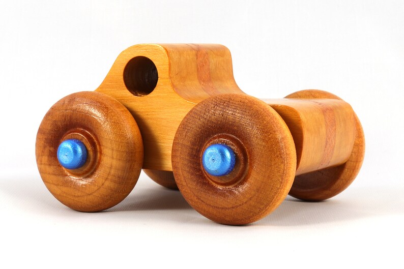 Wood Toy Monster Truck Handmade Form Hardwood and Finished With Amber Shellac With Metallic Saphire Blue Trim.