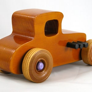 Handmade wooden toy car '27 T-Coupe, finished with amber shellac, metallic purple, and black acrylic paint. Made to order.