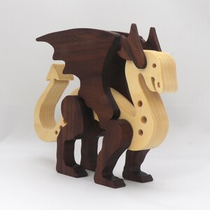 Handmade wooden dragon figurine made from contrasting hardwoods with a light natural wood body and head paired with rich dark reddish-brown wings, legs, and horns.