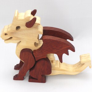 Hand-crafted baby dragon mythical fantasy animal figurine made from contrasting high-quality hardwoods and finished with non-toxic oils and waxes. Perfect for any dragon enthusiast.