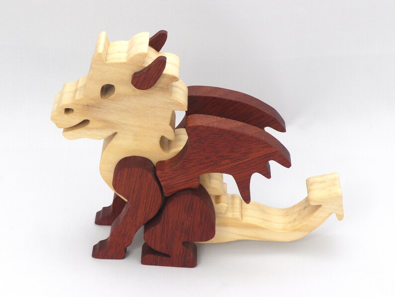 Hand-crafted baby dragon mythical fantasy animal figurine made from contrasting high-quality hardwoods and finished with non-toxic oils and waxes. Perfect for any dragon enthusiast.