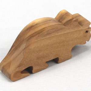 This small wooden triceratops dinosaur toy is crafted from high-quality hardwood and hand-finished. It is a delightful plaything for young children and appeals to many adults.