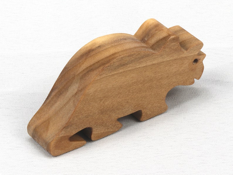 This small wooden triceratops dinosaur toy is crafted from high-quality hardwood and hand-finished. It is a delightful plaything for young children and appeals to many adults.