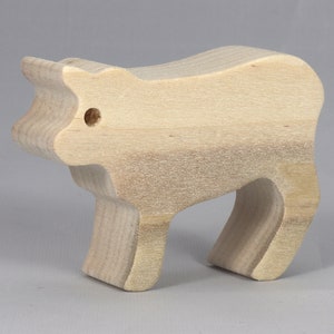 Handmade unfinished wooden toy baby calf cutout, unpainted and ready to paint, freestanding farm animal figure from Odin's Toy Factory’s  Itty Bitty Animal Collection. Handcrafted in Tallahassee, Florida, USA, using reclaimed natural wood offcuts. Perfect for imaginative play, stacking, collectors, and crafting.