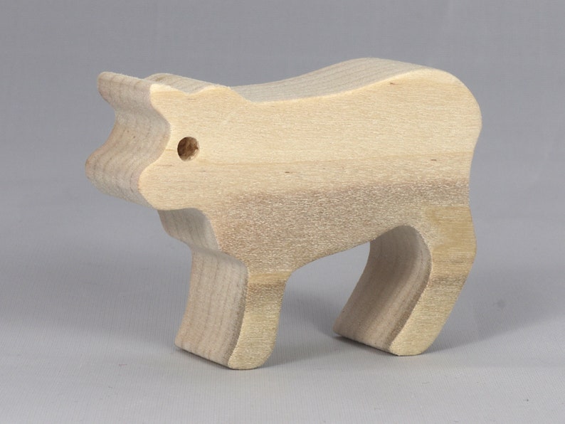 Handmade unfinished wooden toy baby calf cutout, unpainted and ready to paint, freestanding farm animal figure from Odin's Toy Factory’s  Itty Bitty Animal Collection. Handcrafted in Tallahassee, Florida, USA, using reclaimed natural wood offcuts. Perfect for imaginative play, stacking, collectors, and crafting.