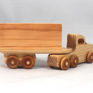 Handmade wooden toy tractor trailer semi truck finished with clear shellac. Crafted from natural wood using traditional woodworking tools. Approximate size 7 inches long. Made in Tallahassee, Florida, USA from Odin's Toy Factory Play Pal Collection.