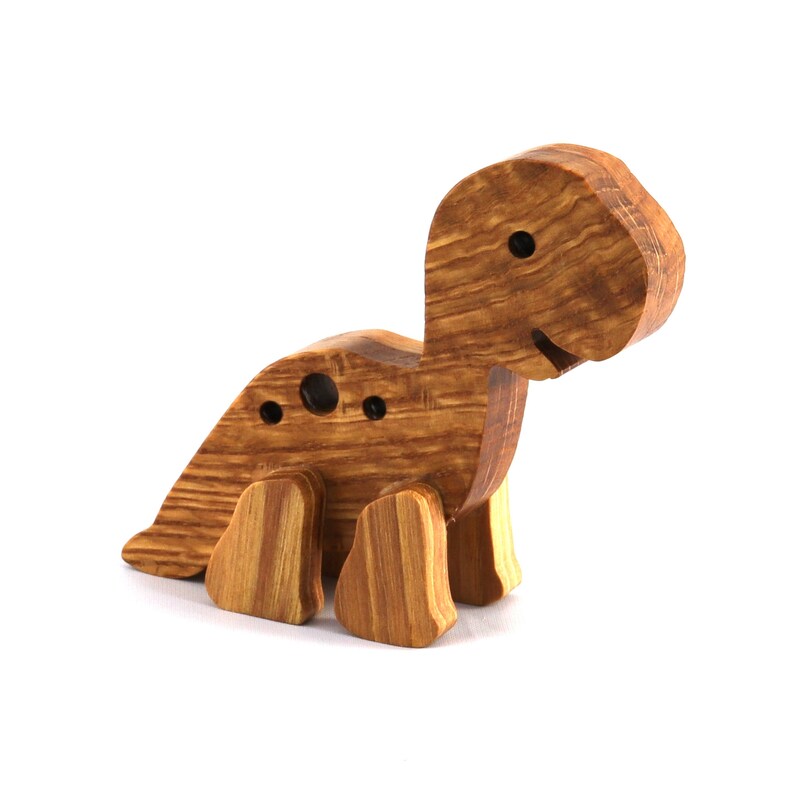 Handmade wooden baby dinosaur figurines, set of 3, made from hardwood with a natural oil and wax finish. Each baby dinosaur measures approximately 3 to 4 inches in height and length. Handmade in Tallahassee, Florida, USA at Odin's Toy Factory.