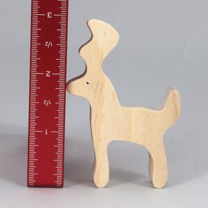Handmade unfinished wooden deer toy figurine, part of the Itty Bitty Animal Collection, shown in natural light wood with visible grain, standing on a white background.