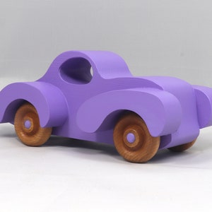 A Handmade Wood Toy Car Fat Fendered Coupe Hand Painted With Amethyst Acrylic Paint And Amber Shellac
