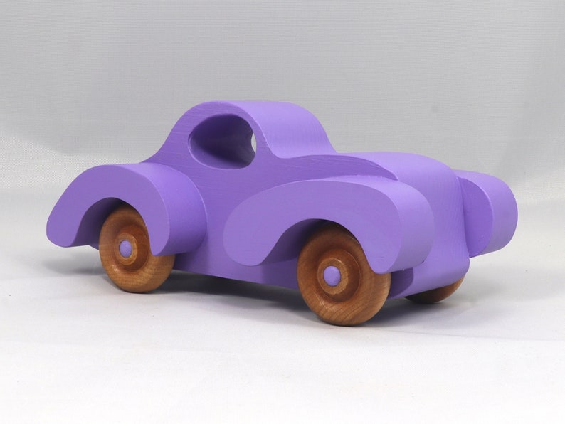 A Handmade Wood Toy Car Fat Fendered Coupe Hand Painted With Amethyst Acrylic Paint And Amber Shellac