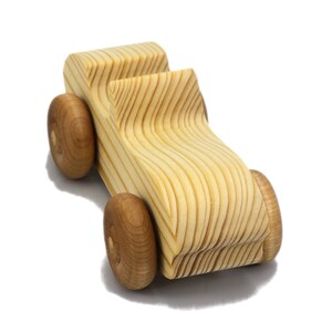 A small, handcrafted wooden toy convertible sports car, finished with a custom blend of oils and waxes, is the perfect gift for young children.