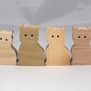 This is an unfinished wooden Sitting Cat cutout from solid wood using traditional woodworking techniques. Sanded smooth and ready to paint, stain, or customize. Freestanding design for small hands, toddlers, young children, crafters, collectors, and display. I take custom orders for any animal, quantity, and mix — including large ornament orders. Mix and match, request a different size, or send a drawing or pattern. Handmade by Odin's Toy Factory in Tallahassee, Florida, USA.