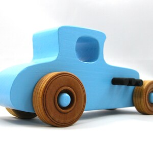 Handmade wooden toy car modeled after a '27 T-Coupe, finished with baby blue and black acrylic paint with nonmarring amber shellac wheels from my hot rod collection.