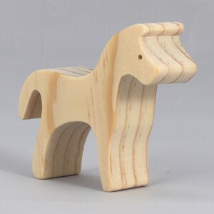 Handmade wooden toy horse cutout, perfect for children's playtime collection. Freestanding and stackable, ready to paint or customize. Endless possibilities for imaginative play, from farm scenes to towering animal creations.
